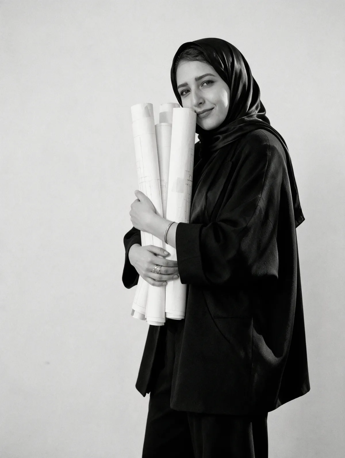 Eng. Kholoud Jamil holding rolled drawings